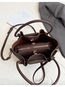 Top view of brown leather bucket bag interior with zipper pouch and gold magnetic closure
