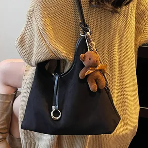 Winter black suede shoulder tote bag with a cute plush bear pendant accessory