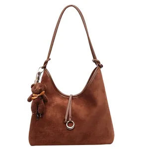 Dark brown faux suede hobo tote bag with knotted shoulder strap and plush bear charm