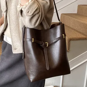 Minimalist large brown bucket bag for women with gold buckle and smooth PU leather finish