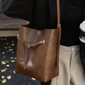 Minimalist brown leather bucket bag for women, spacious shoulder bag for daily commute