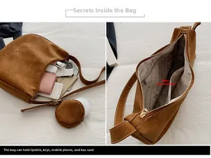 Detail view of brown suede shoulder bag interior with ample space and round pouch