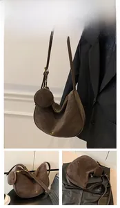 Detail of coffee brown suede hobo bag with adjustable strap and mini round coin purse