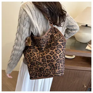 Close-up detail of leopard print tote bag showing premium texture and side snap button