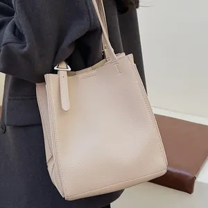 Fashionable off-white lychee grain tote bag with silver hardware for daily wear