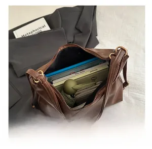 Interior view of large brown vintage tote bag showing ample storage for books and umbrella