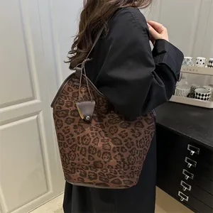 Fashionable leopard print tote bag with long shoulder strap and triangle metal pendant