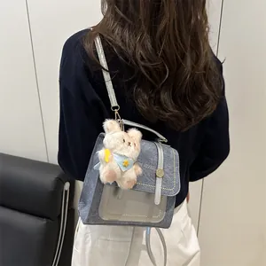 Petit sac à dos en denim bleu avec rabat en cuir argenté et pendentif ours