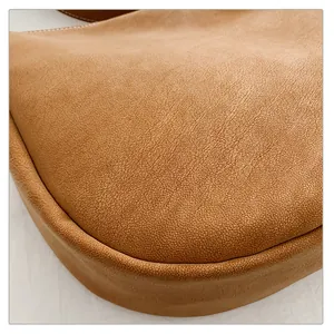 Macro shot of caramel litchi grain leather texture and clean stitching on a vintage bag