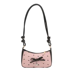 Pink bow underarm bag with black bird pattern and silver heart pendant