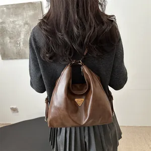 Vintage dark brown leather multi-way backpack and tote bag with metal triangle logo