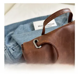 Macro shot of vintage brown leather backpack with reinforced stitching and metal eyelets