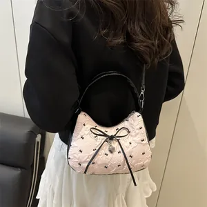 Roze halve maan handtas met zwarte strik en hartvormige hanger van jacquard stof