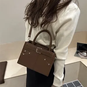 Brown vintage faux leather handbag with silver studs and buckle strap detail