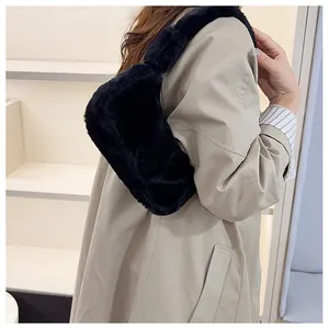 Détail de la texture en fausse fourrure pelucheuse et de la bandoulière du sac hobo noir