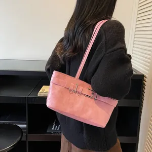 Sac à épaule rose en similicuir avec boucle métallique sur pull en tricot noir