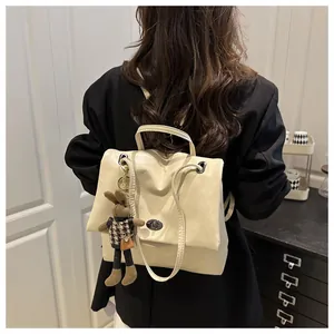 Detail of cream PU leather tote bag with silver twist lock and cute bunny pendant charm