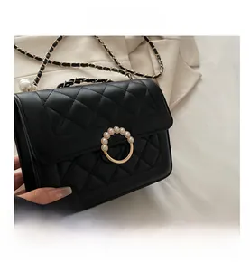 Détails du cuir matelassé noir avec anneau doré et boucle en perles élégante