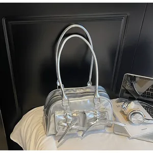 Detail of silver metallic shoulder bag featuring bow pockets and a sleek y2k aesthetic