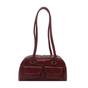 Sleek red patent leather shoulder bag with dual zip pockets and minimalist straps