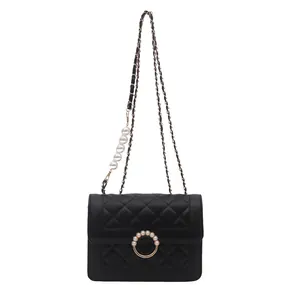 Sac bandoulière noir matelassé avec bandoulière en chaîne dorée et perles blanches