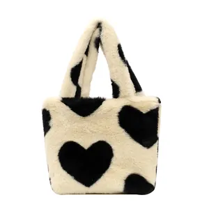 Chic faux fur bucket bag with black heart patterns for autumn and winter fashion