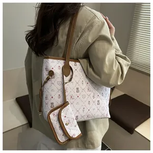 Detail of white tote bag with bear patterns, matching coin purse and brown straps