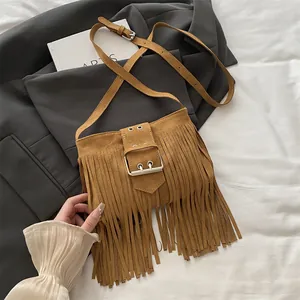 Vintage brown faux suede bucket bag with long fringe tassels and metal buckle detail