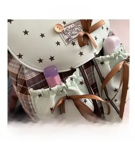 Detail of vintage mint green Oxford backpack with star pattern and drawstring pockets