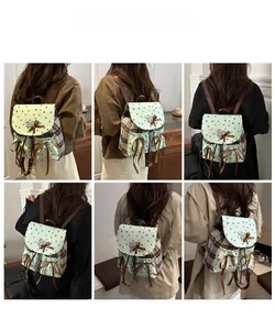 Detailed views of a vintage college style backpack with mint stars and brown plaid