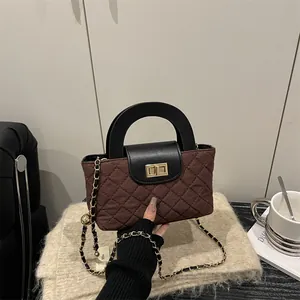 Quilted crossbody chain bag in dark brown with gold buckle and elegant top handle