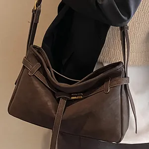 Retro brown large capacity shoulder bag for women with decorative buckles and strap