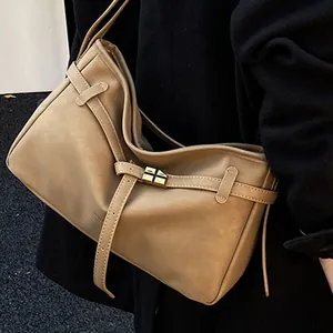 Minimalist khaki leather shoulder bag with gold square buckle and adjustable straps