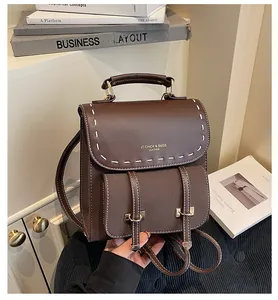 Nahaufnahme des braunen Vintage-Lederrucksacks mit weißen Nähten und Metallschnalle