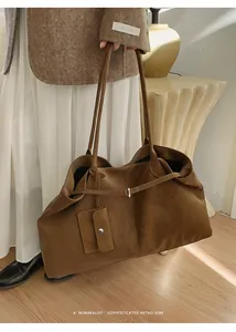 Brown suede tote bag styled with a plaid blazer and long white dress in a retro outfit
