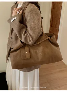 Detail view of large brown vintage tote bag with matching mini coin purse accessory