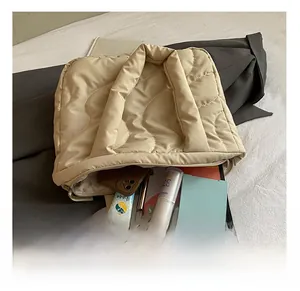 Detailed internal view of beige quilted tote bag showing large capacity and items
