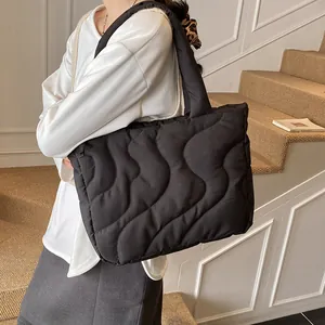 Large black quilted tote bag with wave pattern for women, ideal for winter daily commute