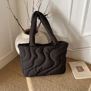 Large capacity black quilted tote bag with wavy stitching and minimalist cloud texture