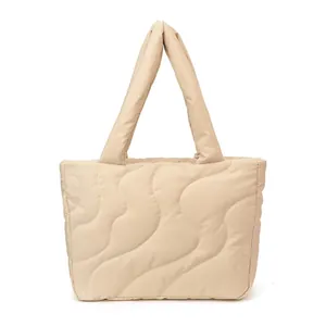 Large beige quilted tote bag with wave stitching for daily winter fashion and commuting