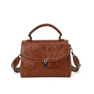 Retro caramel brown crossbody box bag with contrast stitching and woven strap