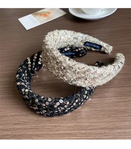 Detailed macro view of woven tweed headband texture with sequins and handmade label