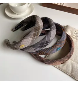 Detail of four retro plaid padded headbands with handmade labels and side buttons