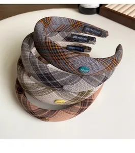 Detailed view of four colorful plaid padded headbands with Korea and Handmade tags