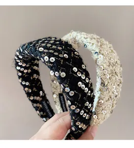 Detail of handmade sequined tweed headbands in black and white with woven fibers