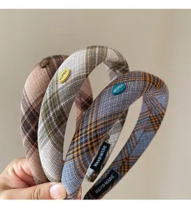 Detail of plaid headbands with Korea metal tag and handmade label on fabric inner band