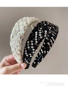 Detail of tweed headband with sequins and a handmade woven label showing high texture