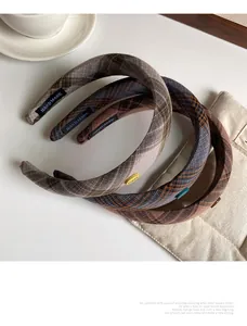 Detail of plaid padded headbands with hand made label and retro fabric texture