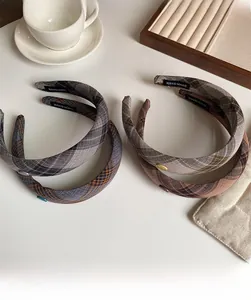 Set of four vintage plaid fabric headbands with handmade tags in brown and blue tones