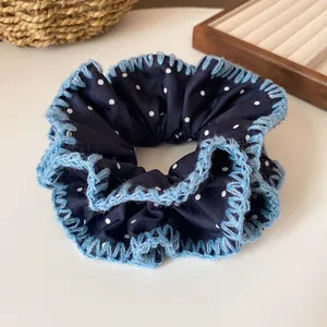 Navy blue polka dot scrunchie with light blue crochet lace edge for women's hair styling